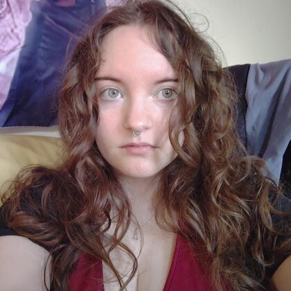 A profile photo of Niamh with long brown curly hair